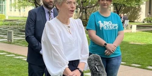 Julie Price, CCC Exec Director speaking outside at Canberra