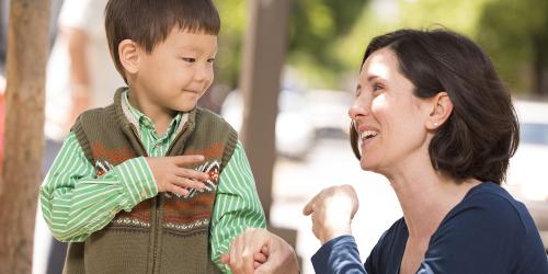 Educator and a child communicating using sign language